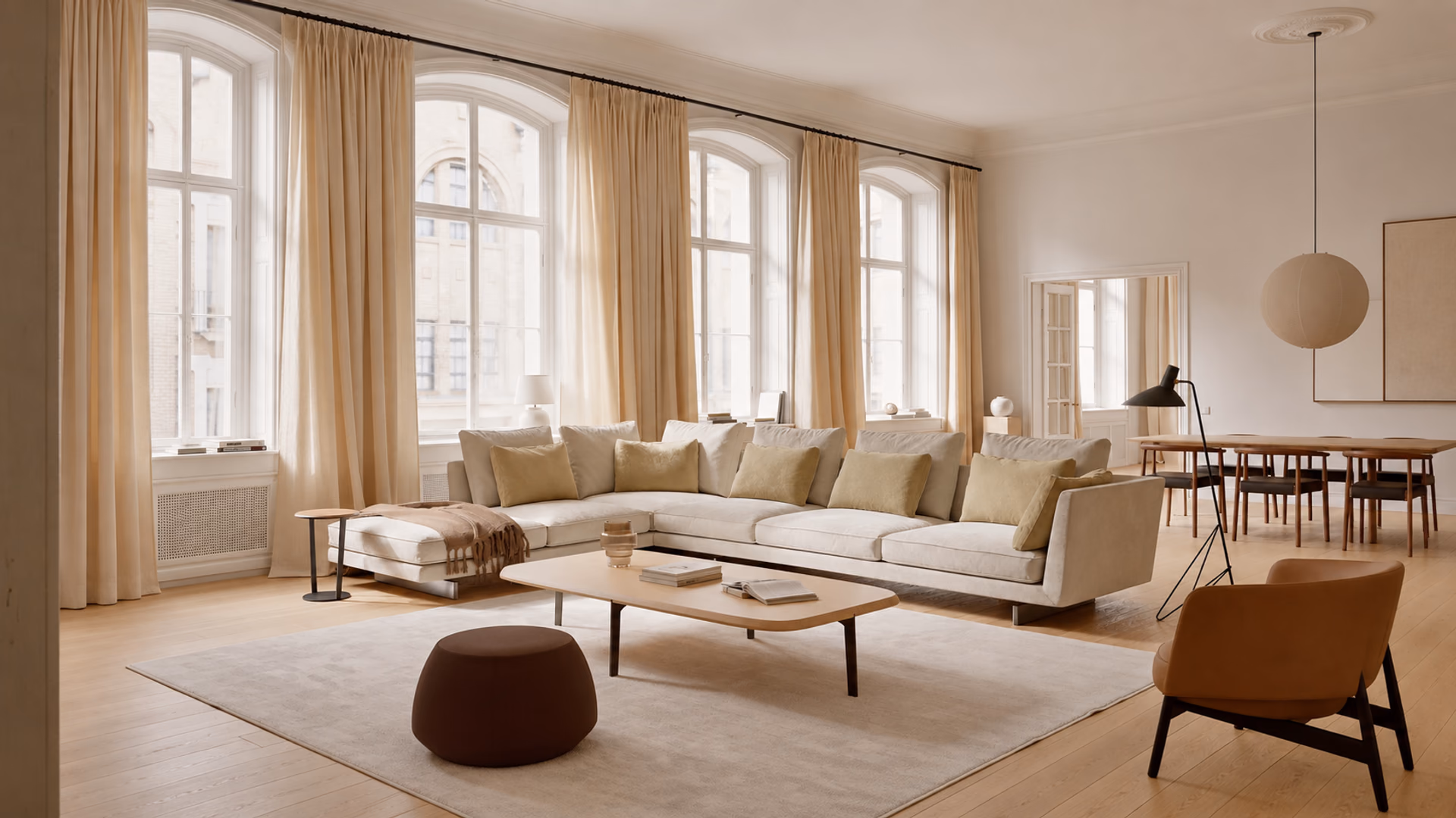 Bensen Savoy sectional sofa with pale upholstery, a wood coffee table and lounge seating in a bright living room.