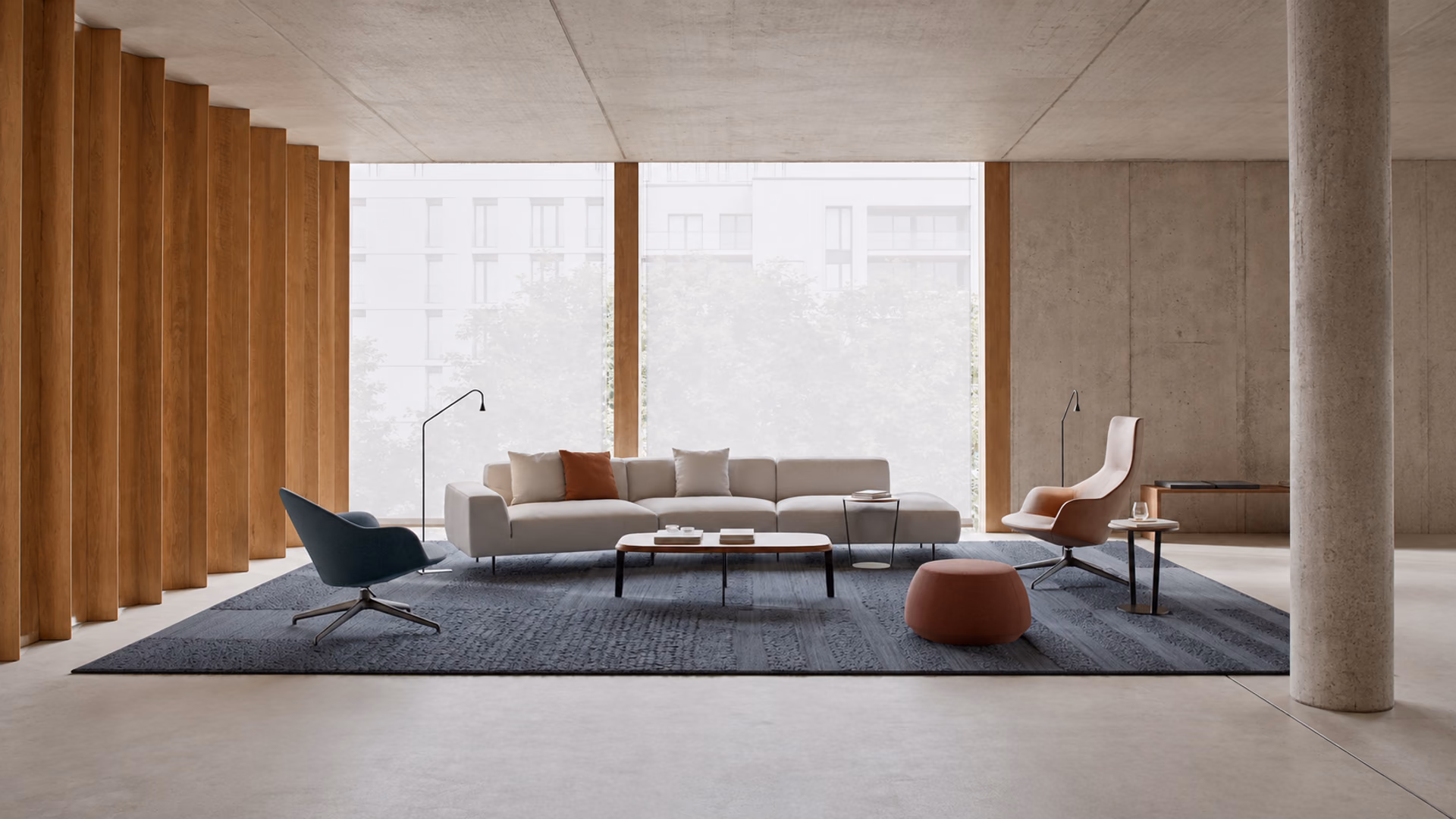 Bensen Endless sofa with two lounge chairs and low tables in a modern room with wood and concrete finishes.
