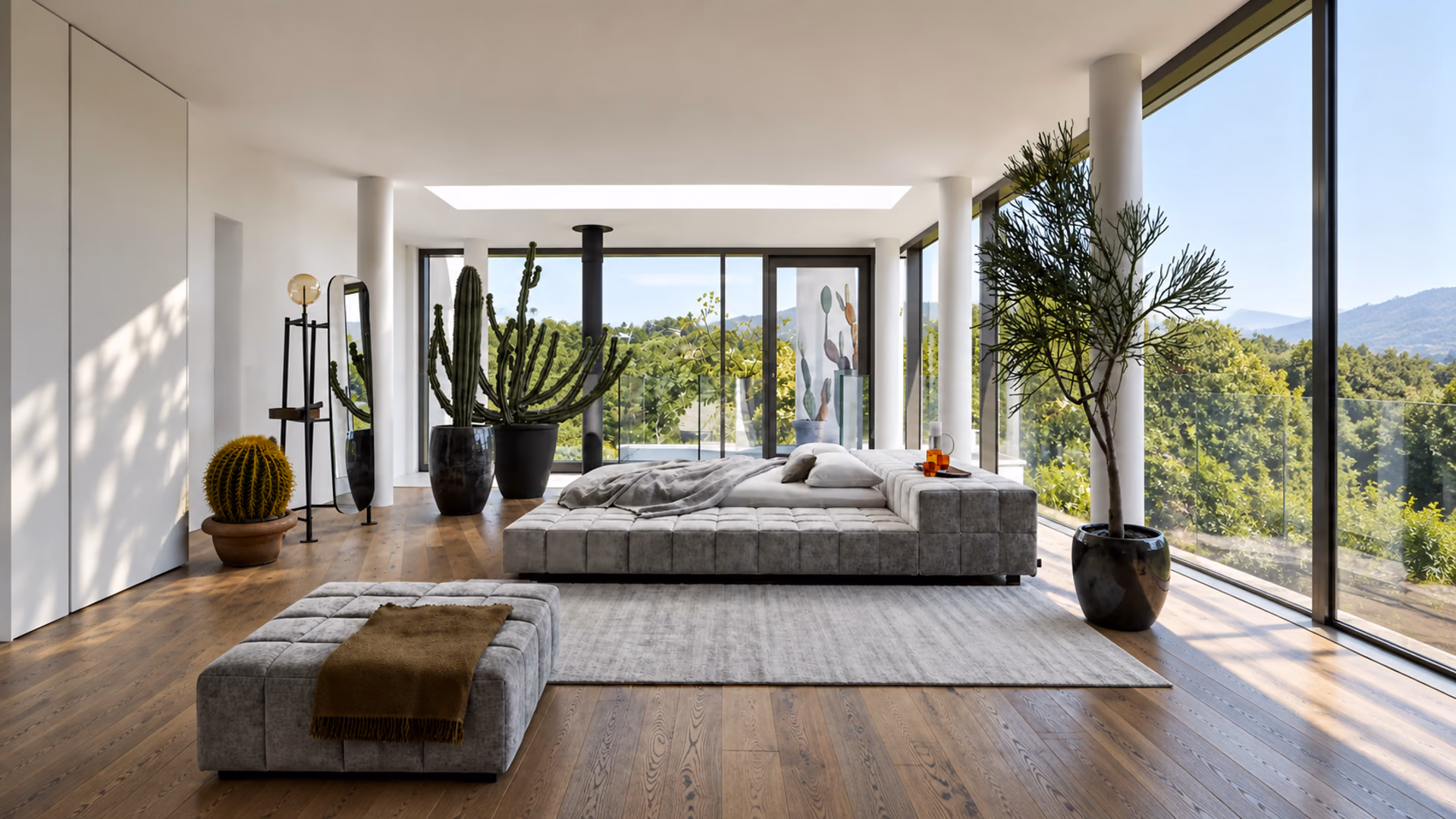 Bonaldo upholstered bed and matching ottoman in a bright bedroom with wood floors and large windows.