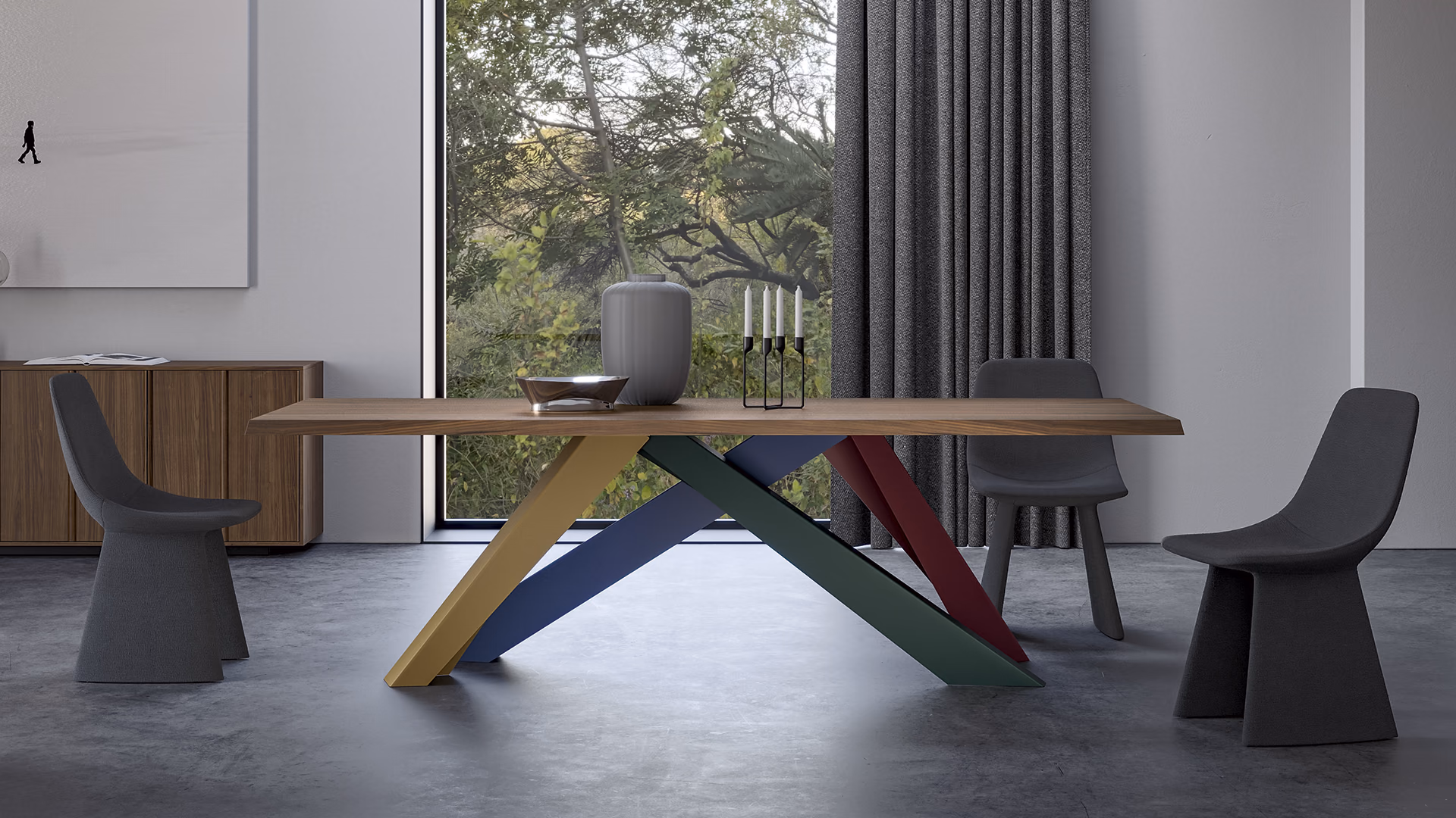 Bonaldo Big Table with a wood top and angled multicolored legs, paired with gray dining chairs.