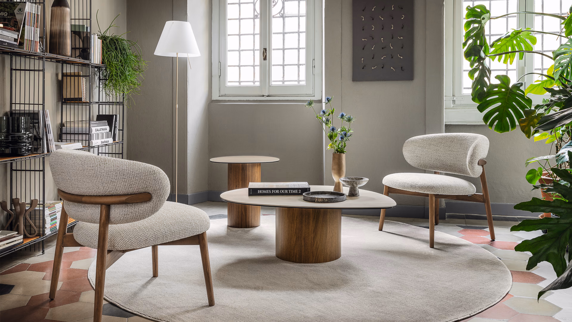 Calligaris Oleandro lounge chairs with wood frames and pale upholstery around low tables.
