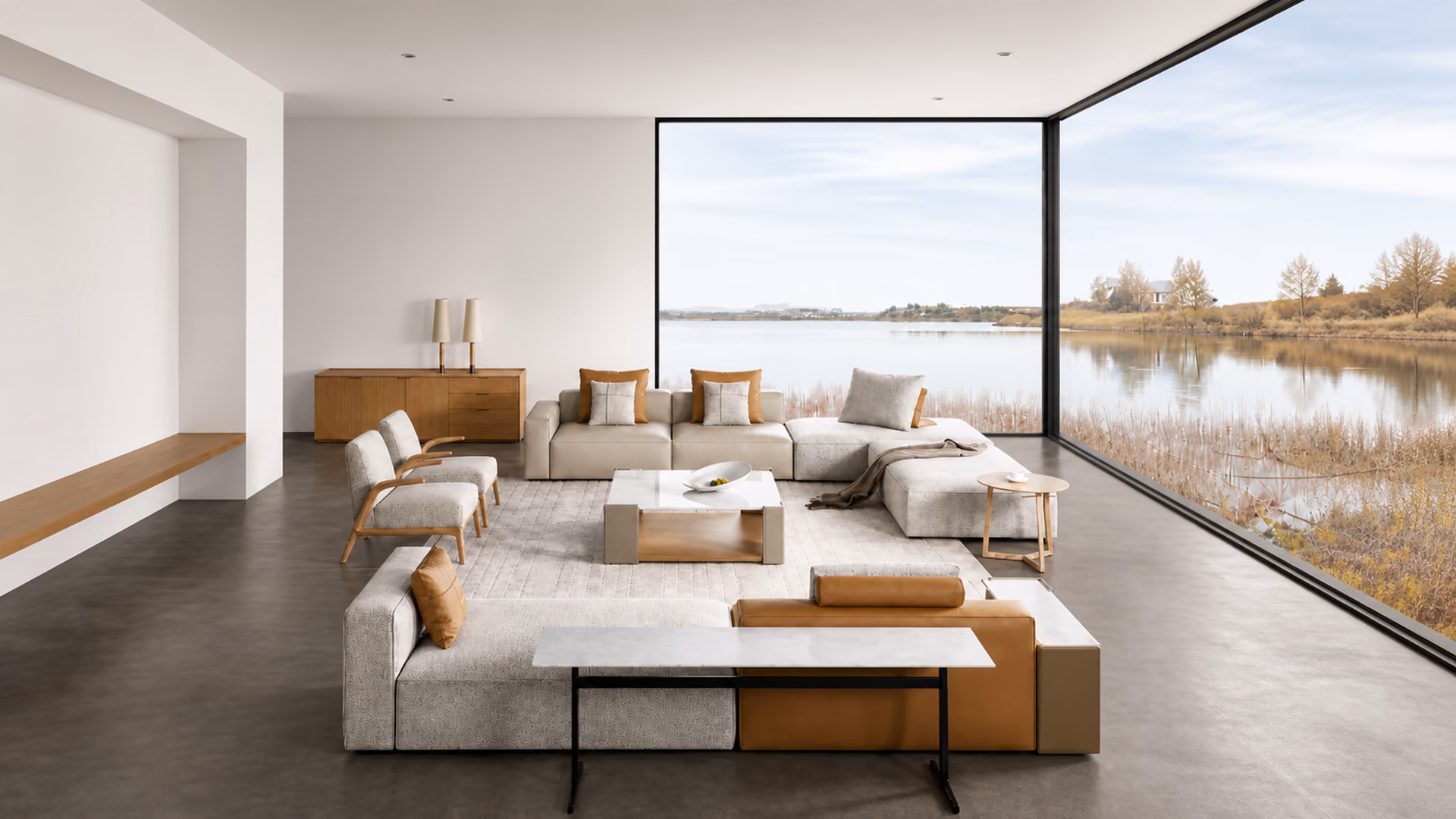Camerich pale modular sofas with wood accent chairs and low tables in a glass-walled lakeside living room.