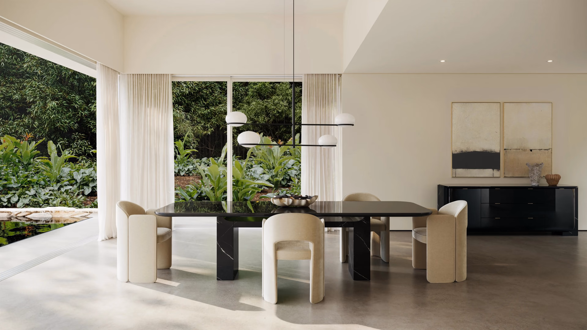Caracole dark dining table and cream upholstered chairs with a matching sideboard in a garden-facing room.