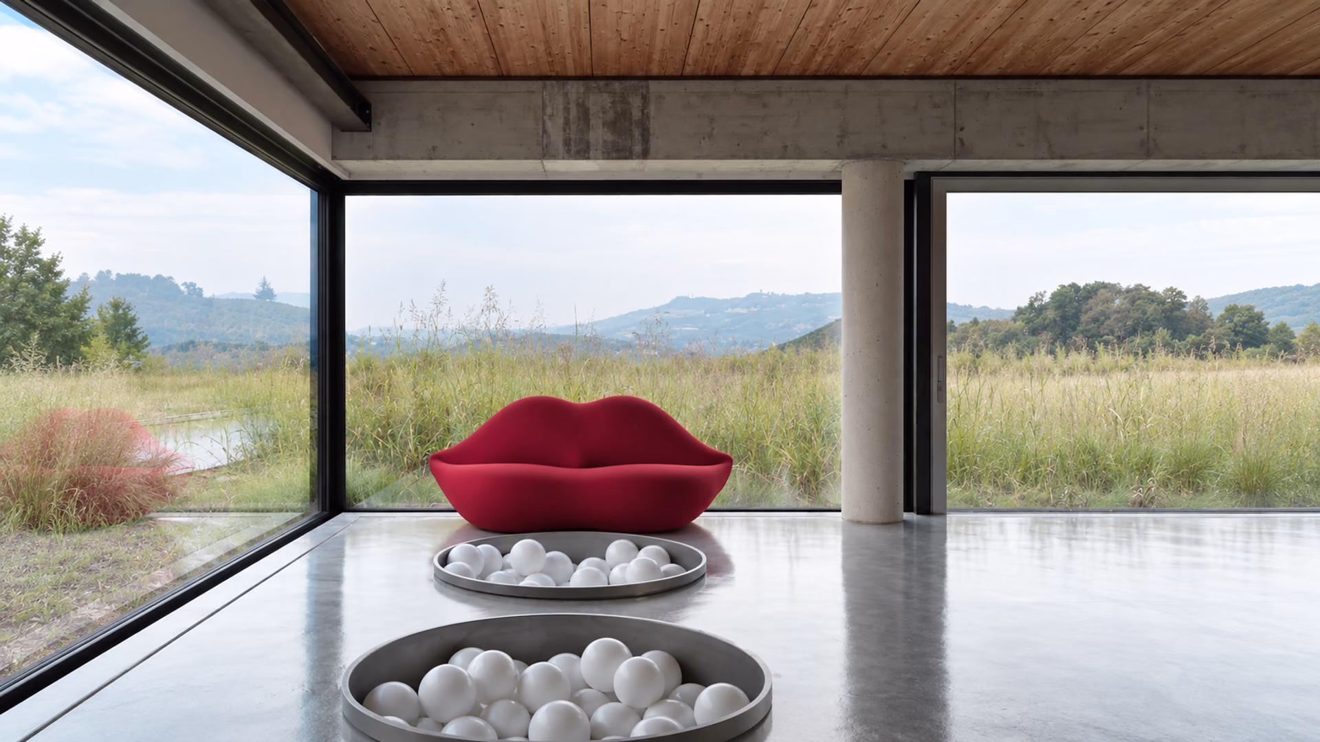 Gufram Bocca Unlimited lip-shaped sofa beside full-height windows