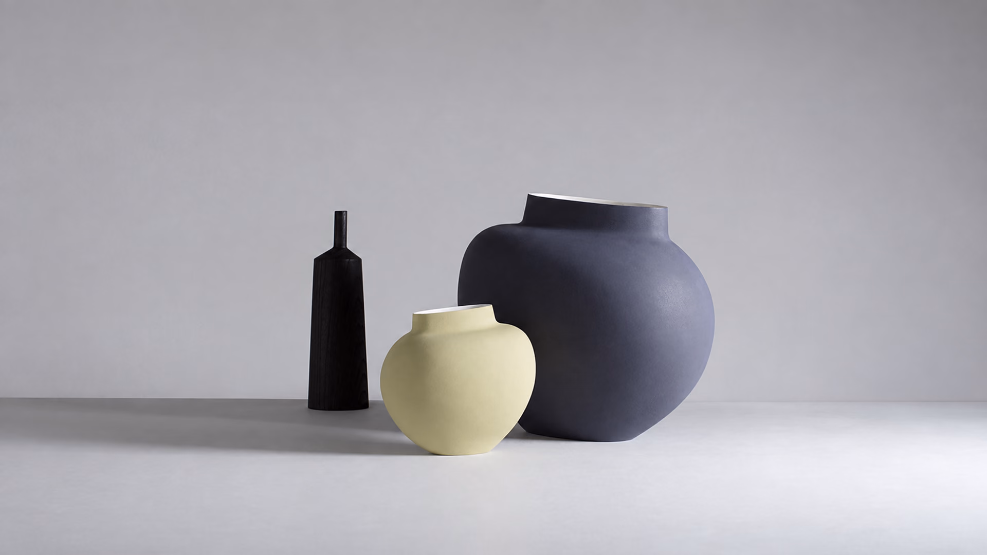 Kose Vaso ceramic vessels in blue, pale yellow and black
