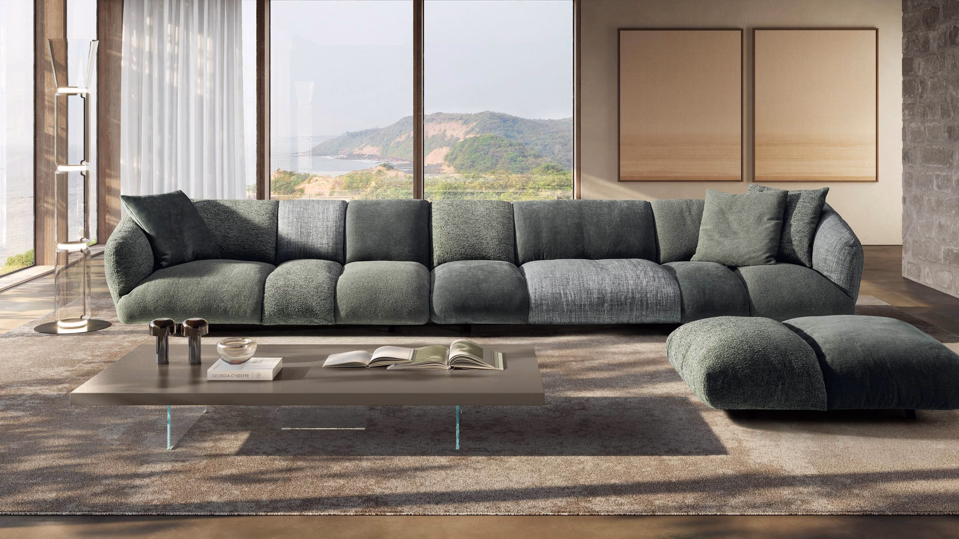 Green LAGO sofa and chaise with a glass-supported coffee table beside large windows