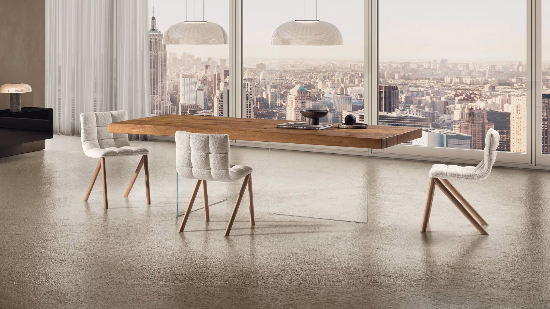 LAGO wood dining table on glass legs with upholstered Mezzaria chairs and a city view