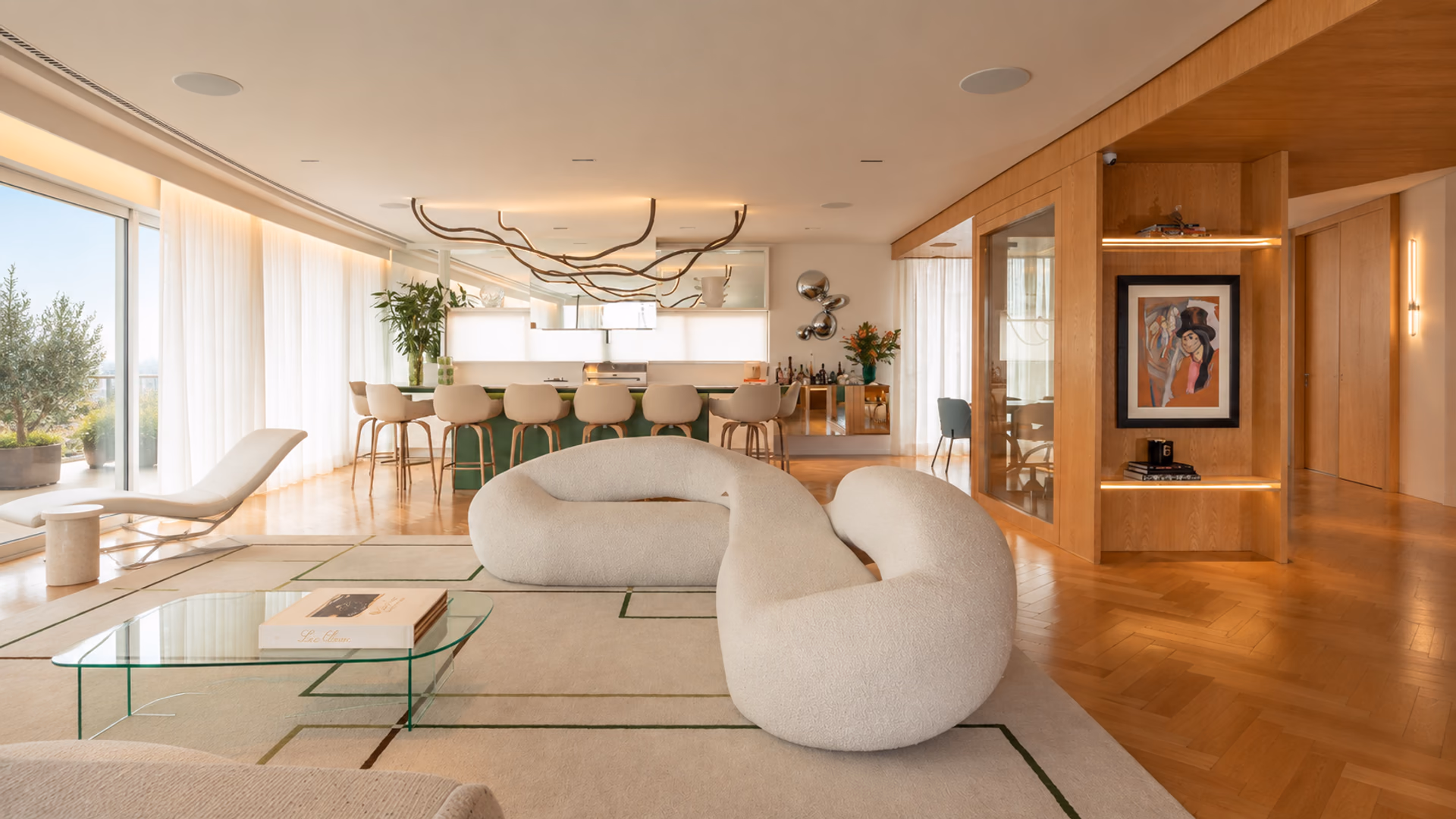 Natuzzi Italia curved white sofas in an open living space beside a kitchen