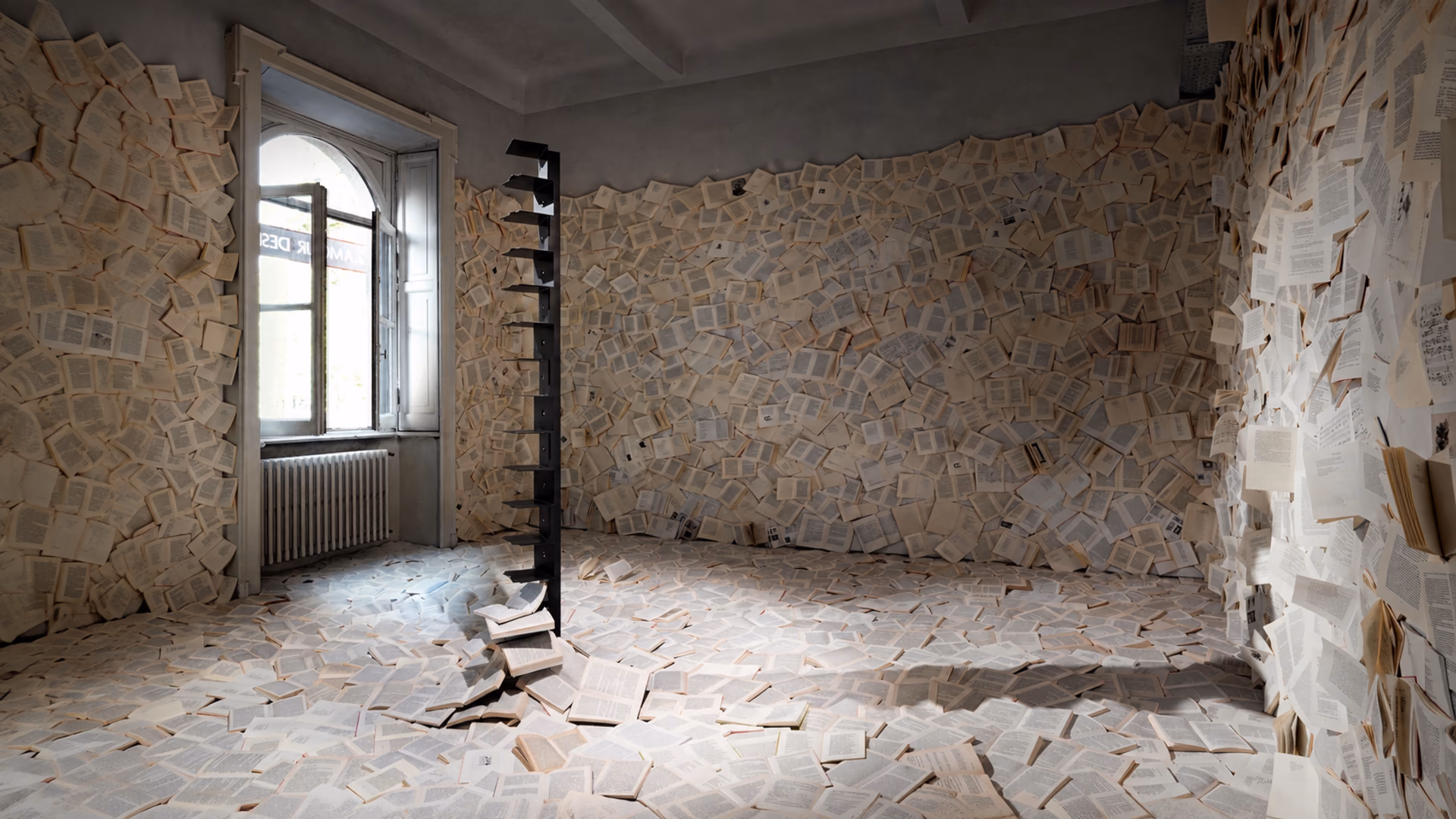 Opinion Ciatti Original Ptolomeo bookcase in a room covered with open book pages