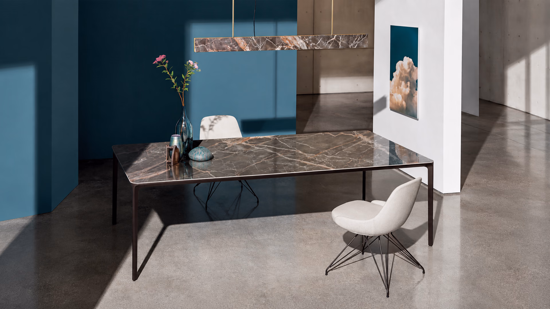 Sovet Slim Rectangular dining table with a thin dark frame and pale chairs