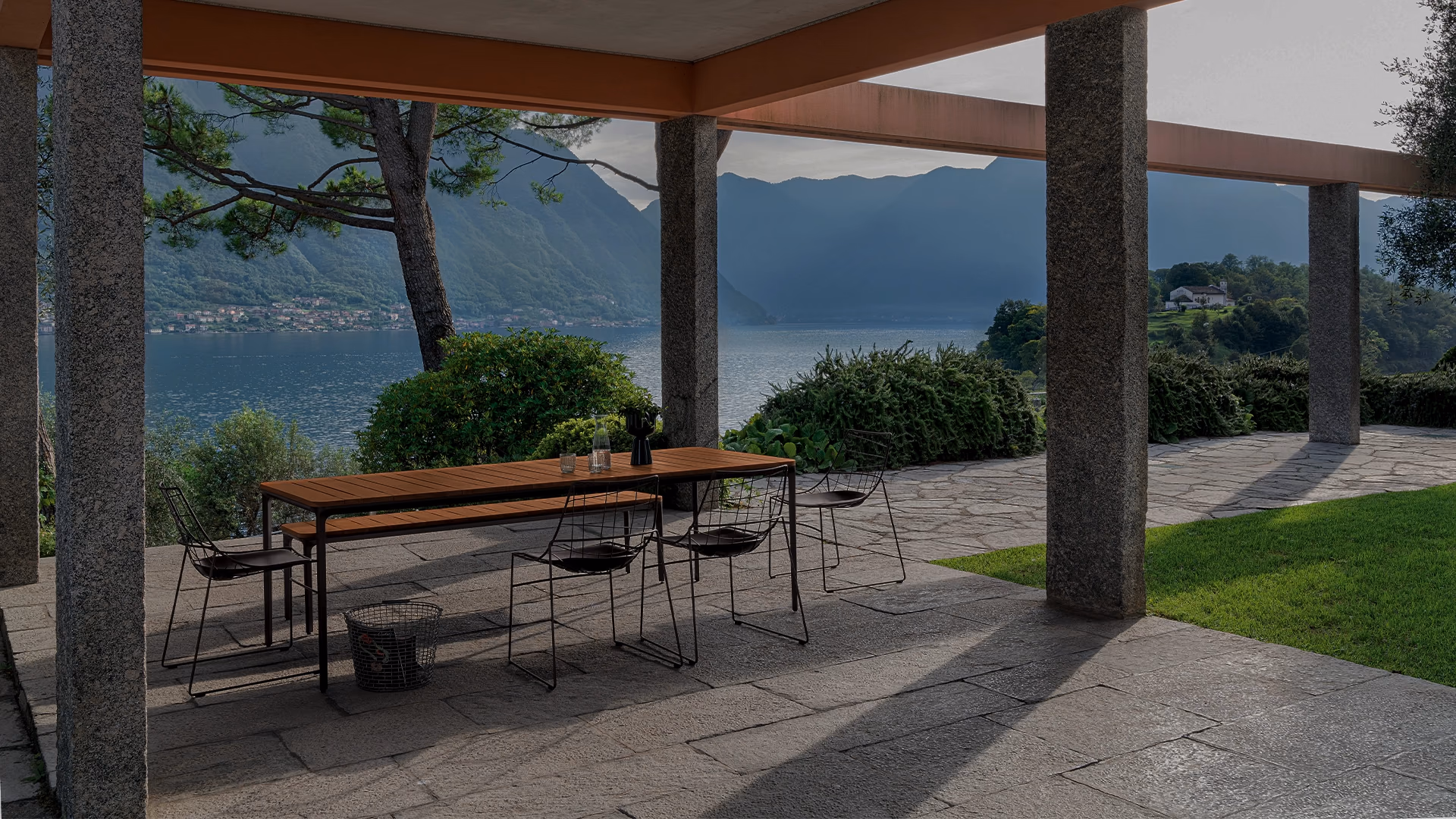 Sovet outdoor dining furniture on a covered lakeside terrace