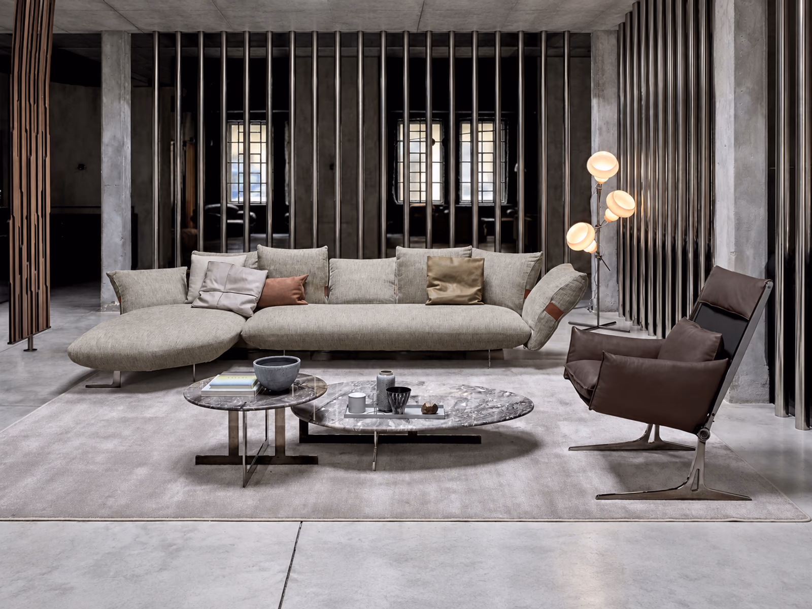 Arketipo: A Smooth Operator sofa anchors a lounge with layered cushions and low occasional tables.