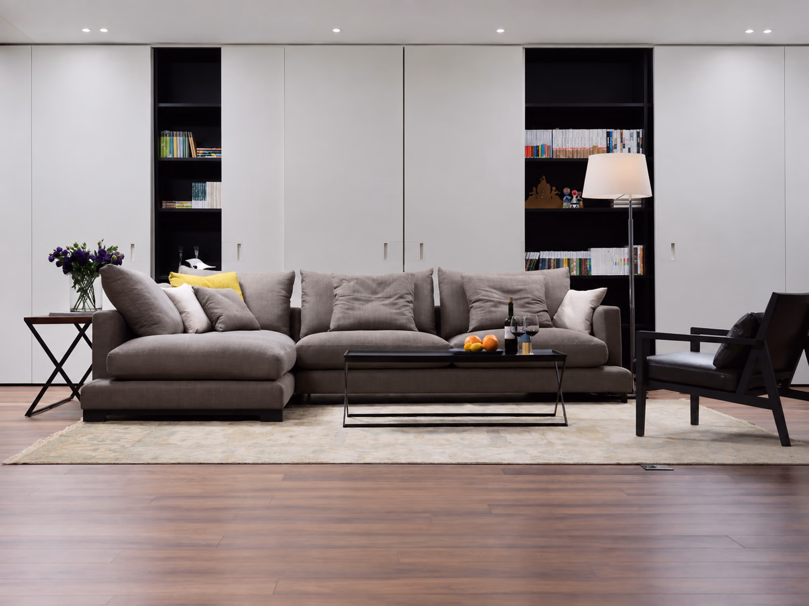 Camerich: A gray LazyTime sofa with a chaise sits against a wall of books and white cabinetry.