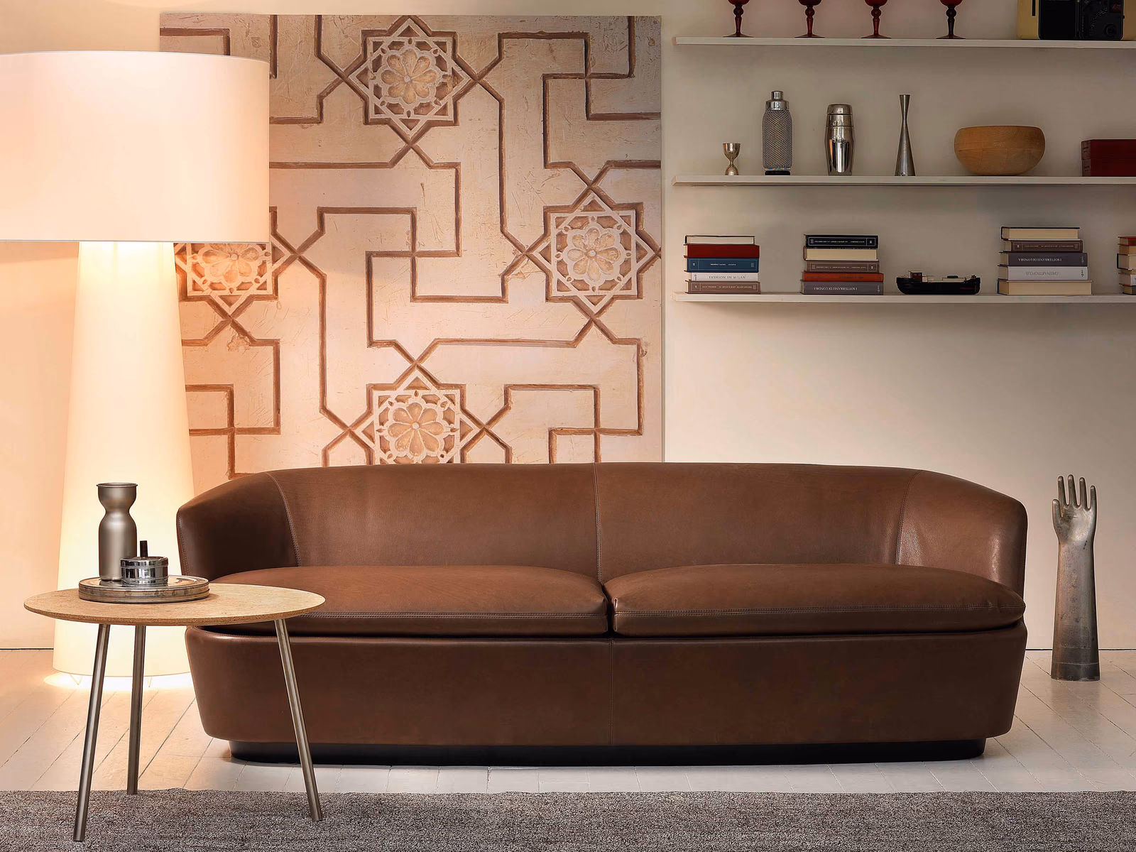 Cappellini: A brown Orla sofa brings a softly rounded silhouette to a contemporary lounge.