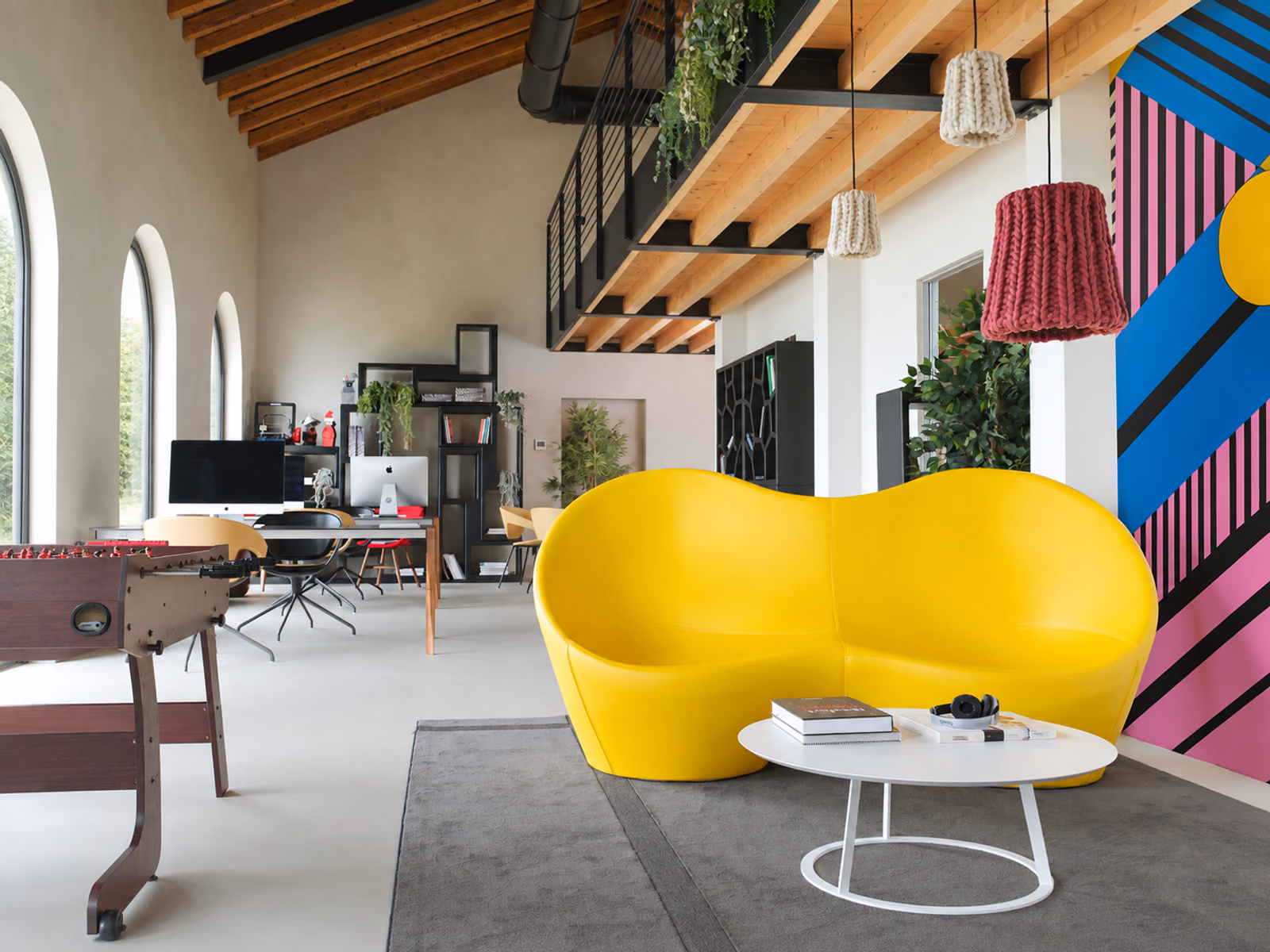 Casamania: A yellow Kouch sofa adds sculptural seating and a strong color accent to the room.