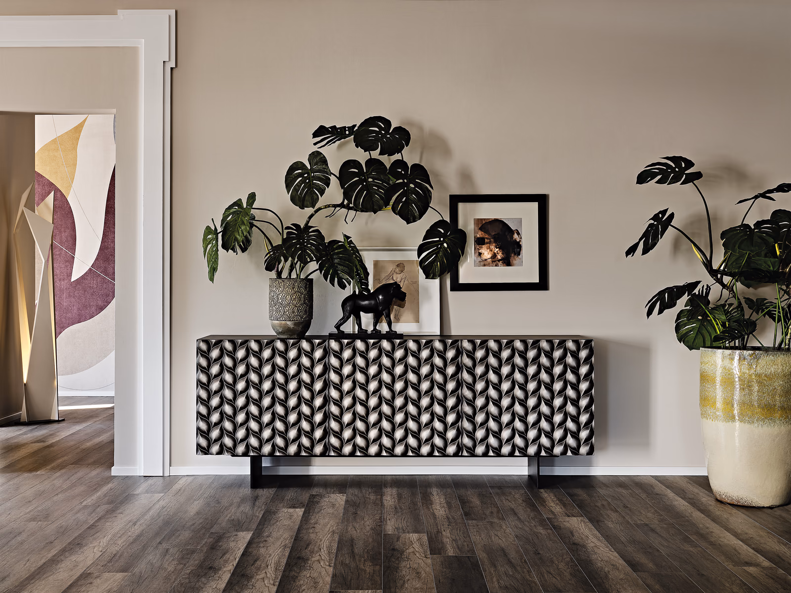 Cattelan Italia: A Lavander sideboard with a geometric facade is styled with plants and framed artwork.