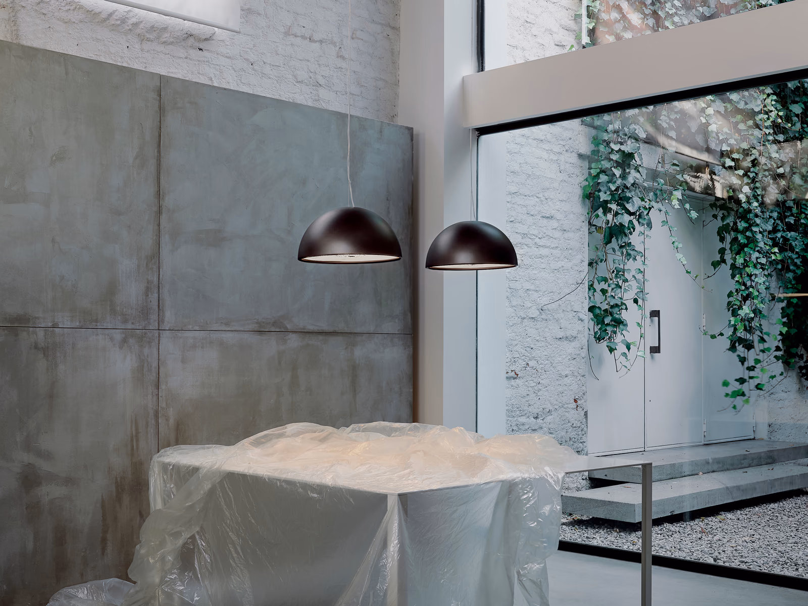 Flos: A Skygarden pendant hangs over a contemporary dining setting.