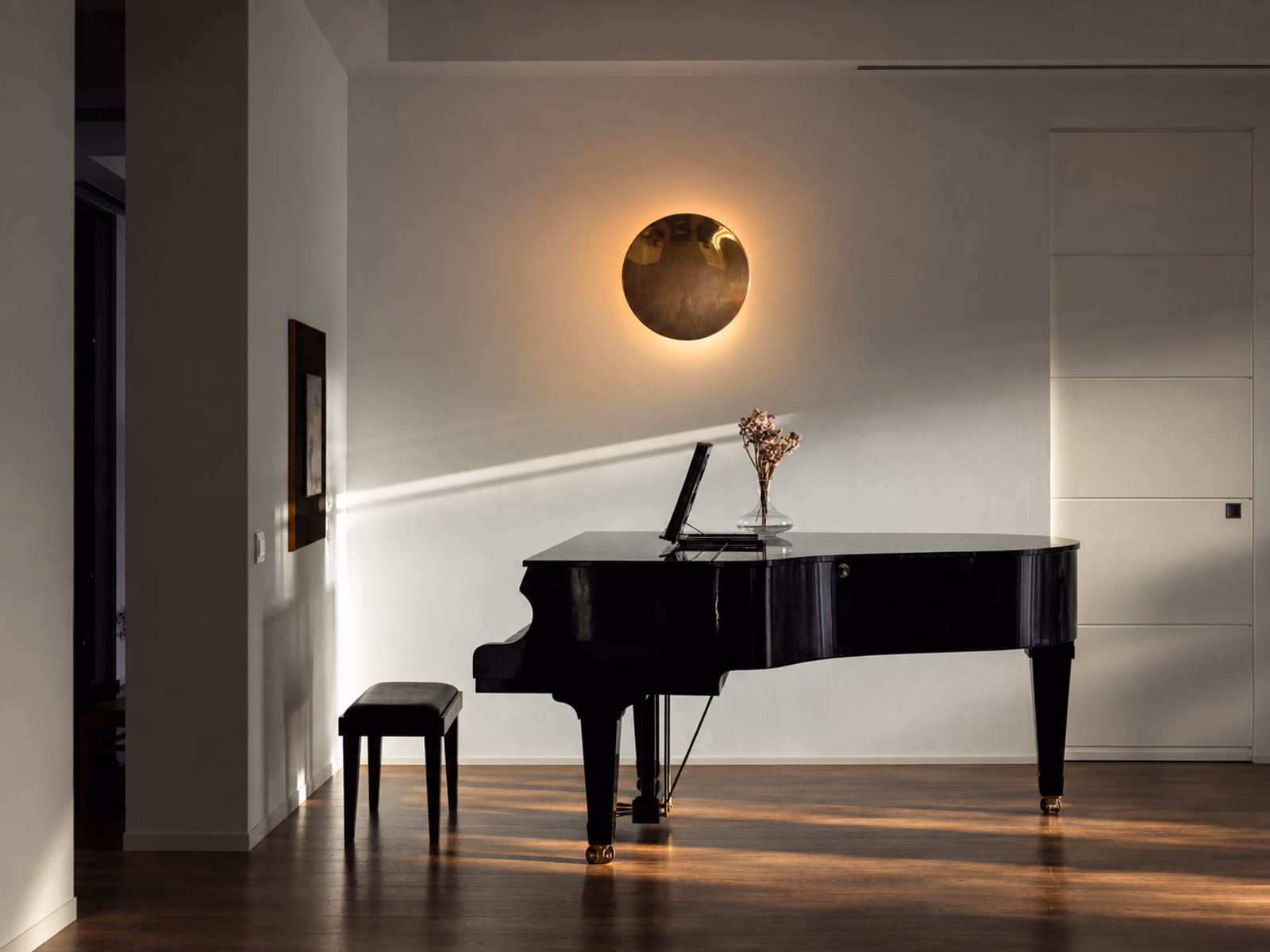 Foscarini: An Anoor light adds a circular focal point to a warm interior with a piano.