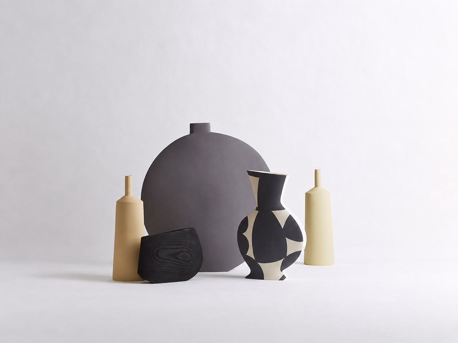 Kose: A patterned Braque vase is grouped with tall vessels and rounded ceramic forms.