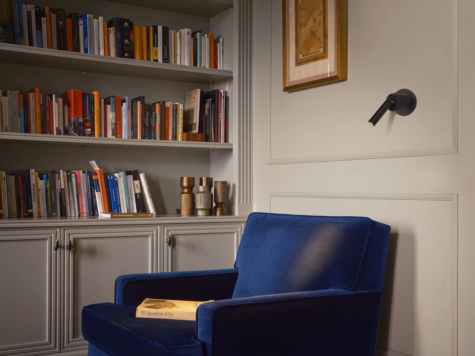 Marset: Ledtube lighting is integrated into a quiet interior with shelving and books.