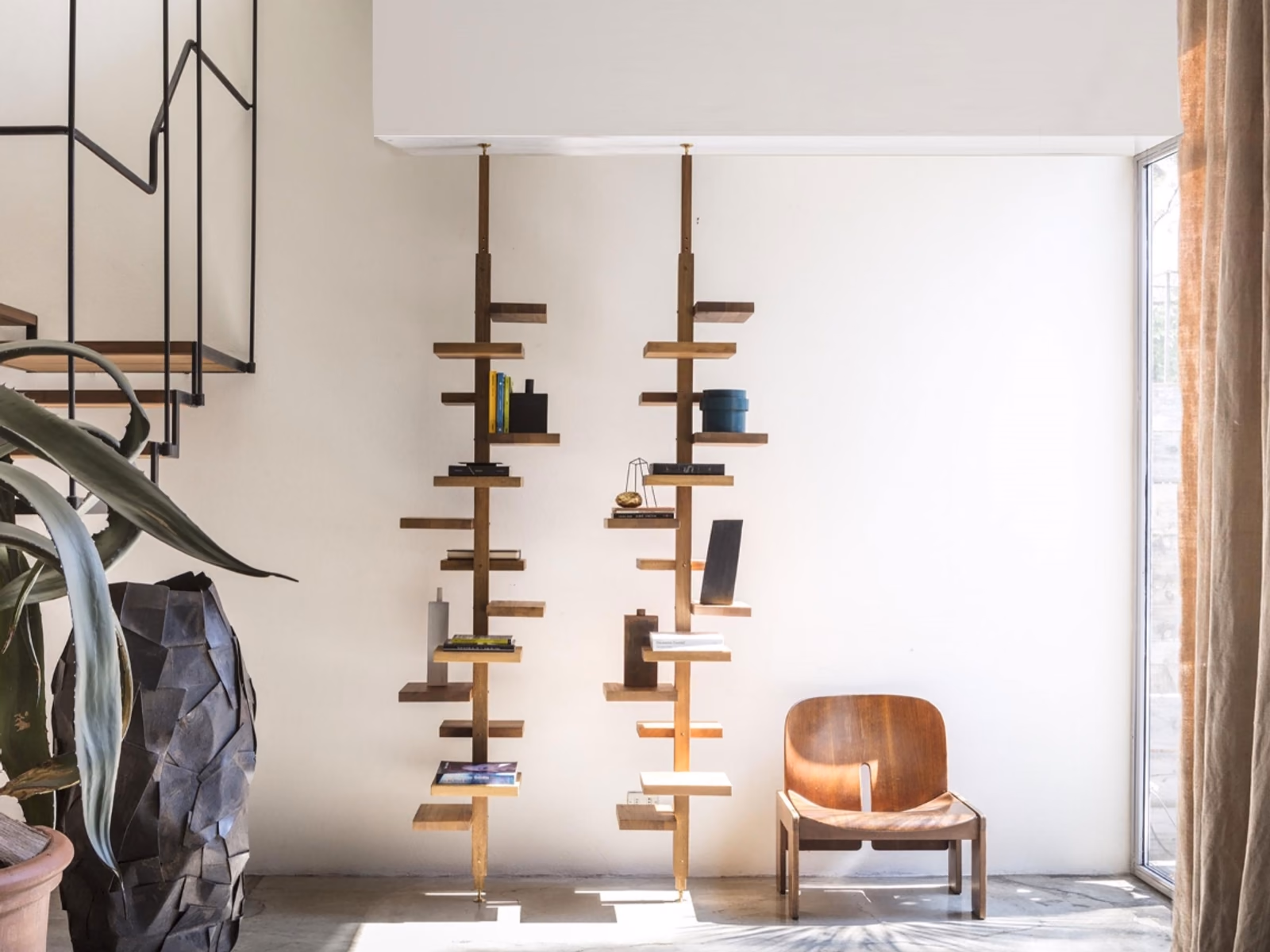 Mogg: An Adelaide Wood shelving composition adds sculptural storage to a furnished interior.