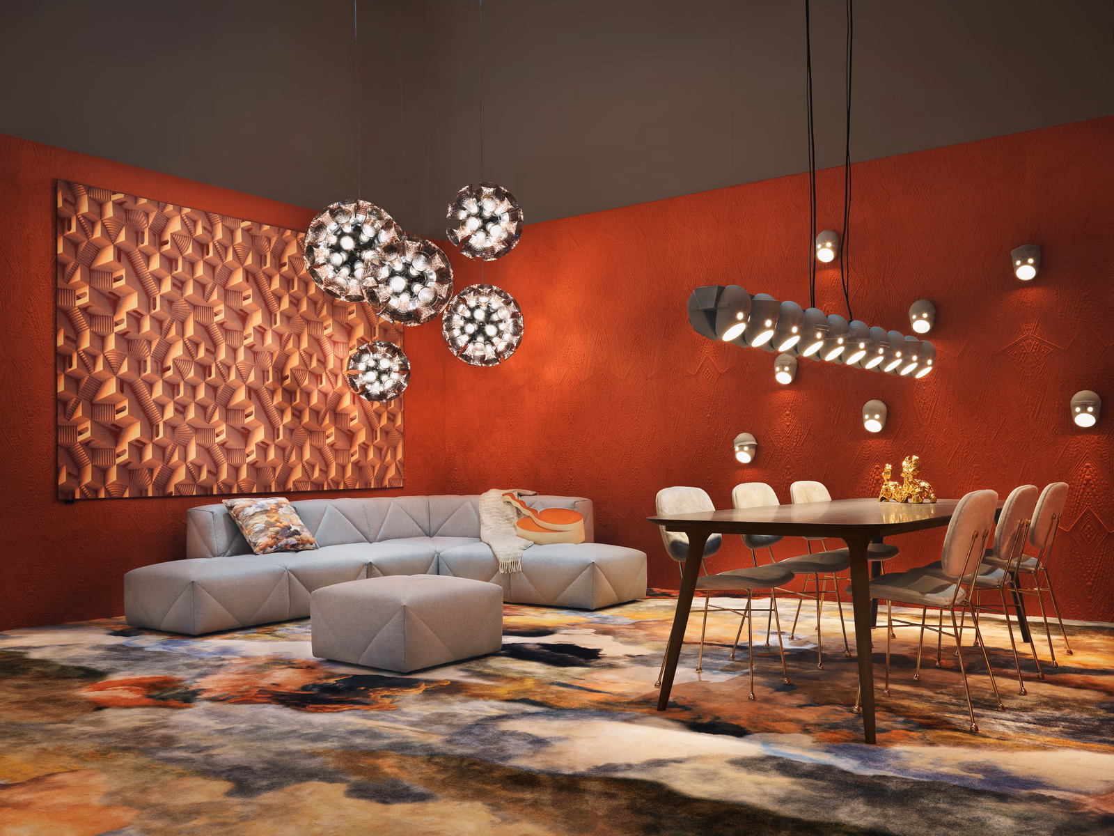 Moooi: A pale BFF sofa contrasts with red walls and sculptural lighting in a furnished living and dining space.