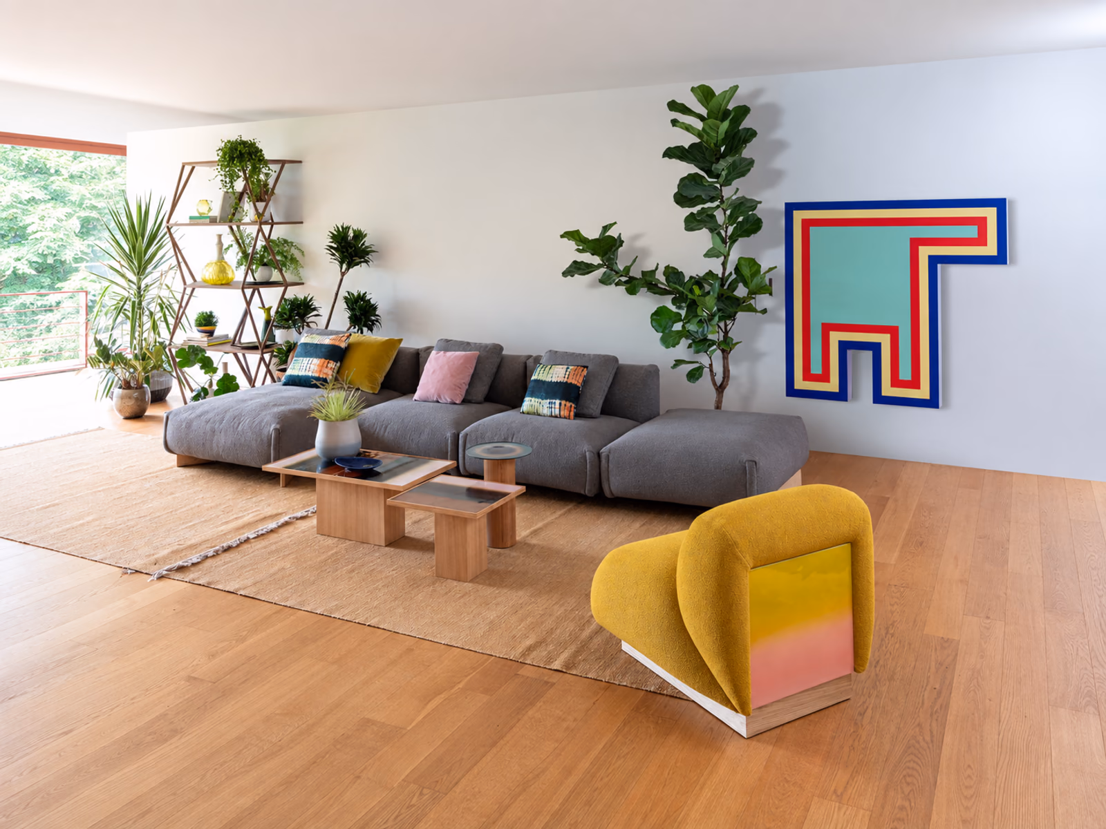 Moroso: A gray Cuadra-soft sofa pairs with a yellow lounge chair, wood tables and graphic artwork.