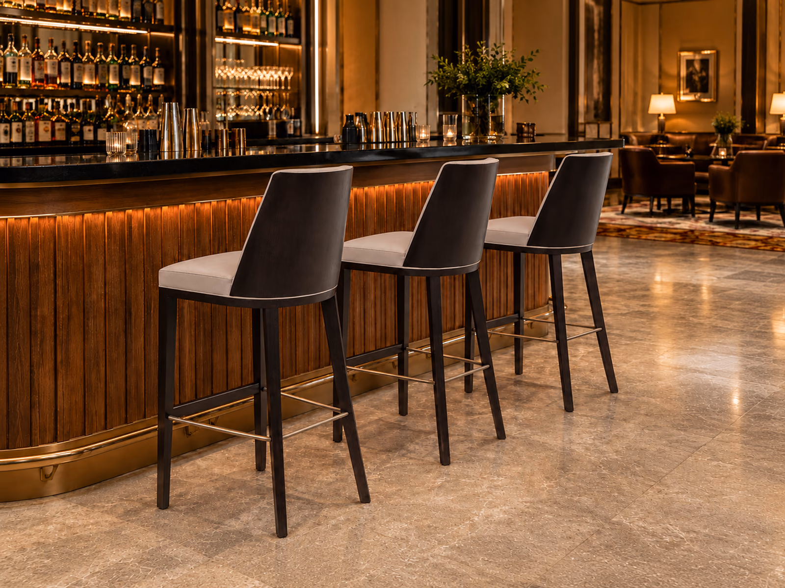 Peressini Casa: Cora W Alto stools line a softly lit bar with warm wood and dark upholstery.