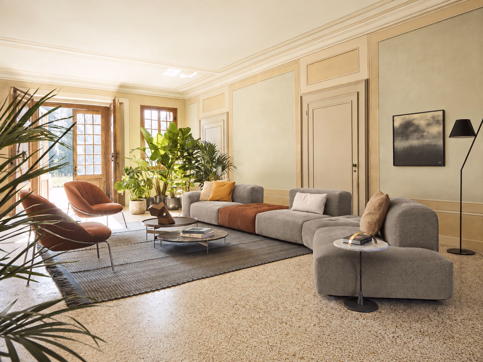 Pianca: Gray and terracotta Delano up modules create a generous lounge in a bright, plant-filled room.