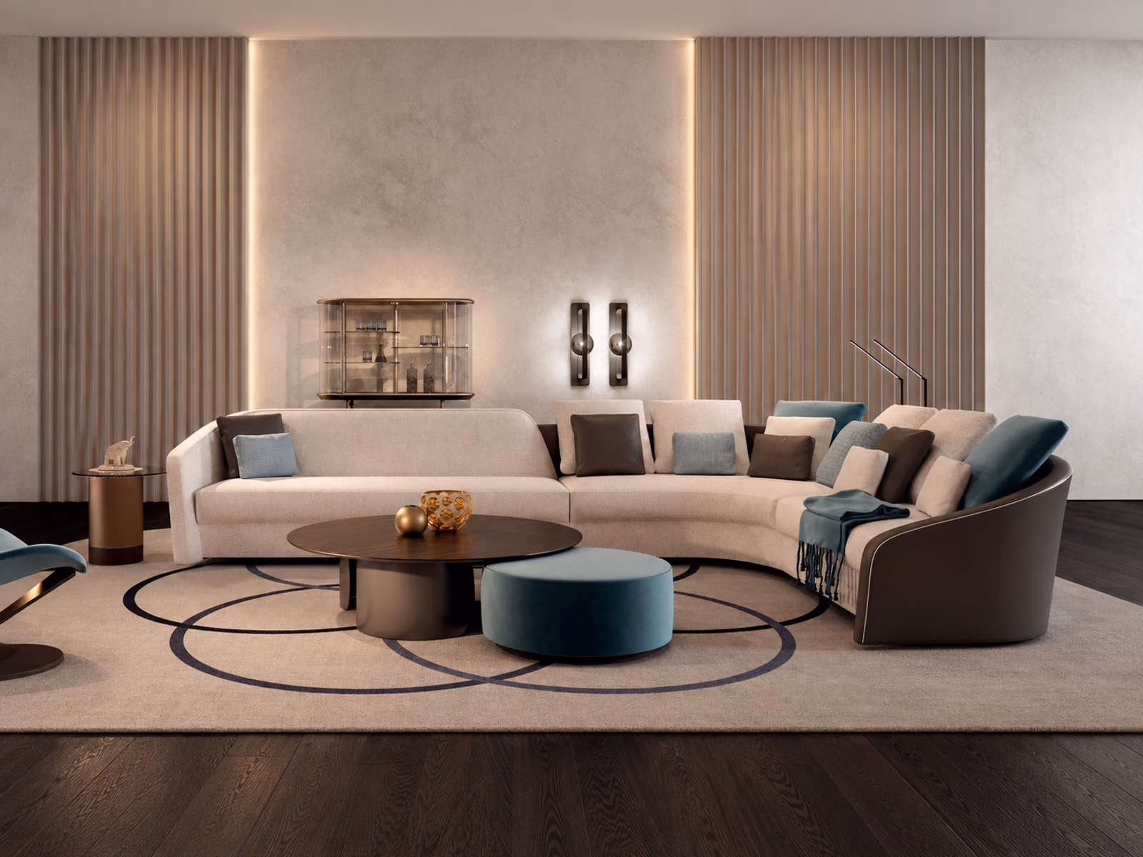 Reflex: A pale Stratum sofa with a dark outer frame surrounds low tables and a blue upholstered pouf.