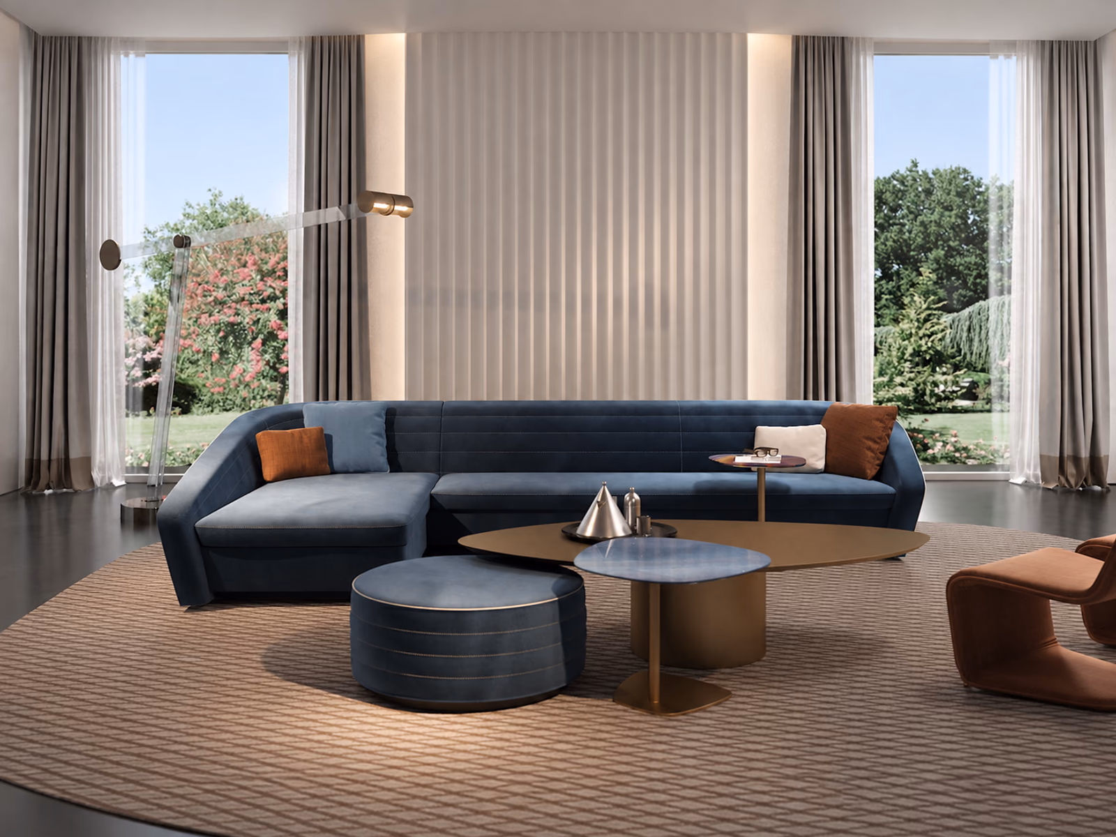 Reflex: A blue Granturismo sofa with a chaise pairs with occasional tables and a matching round pouf.