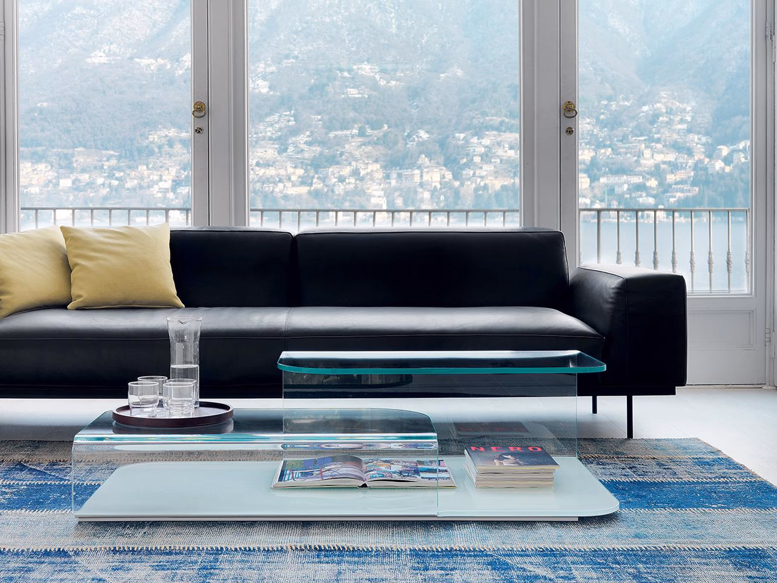 Sovet: A Hug coffee table is shown beside black upholstered seating.