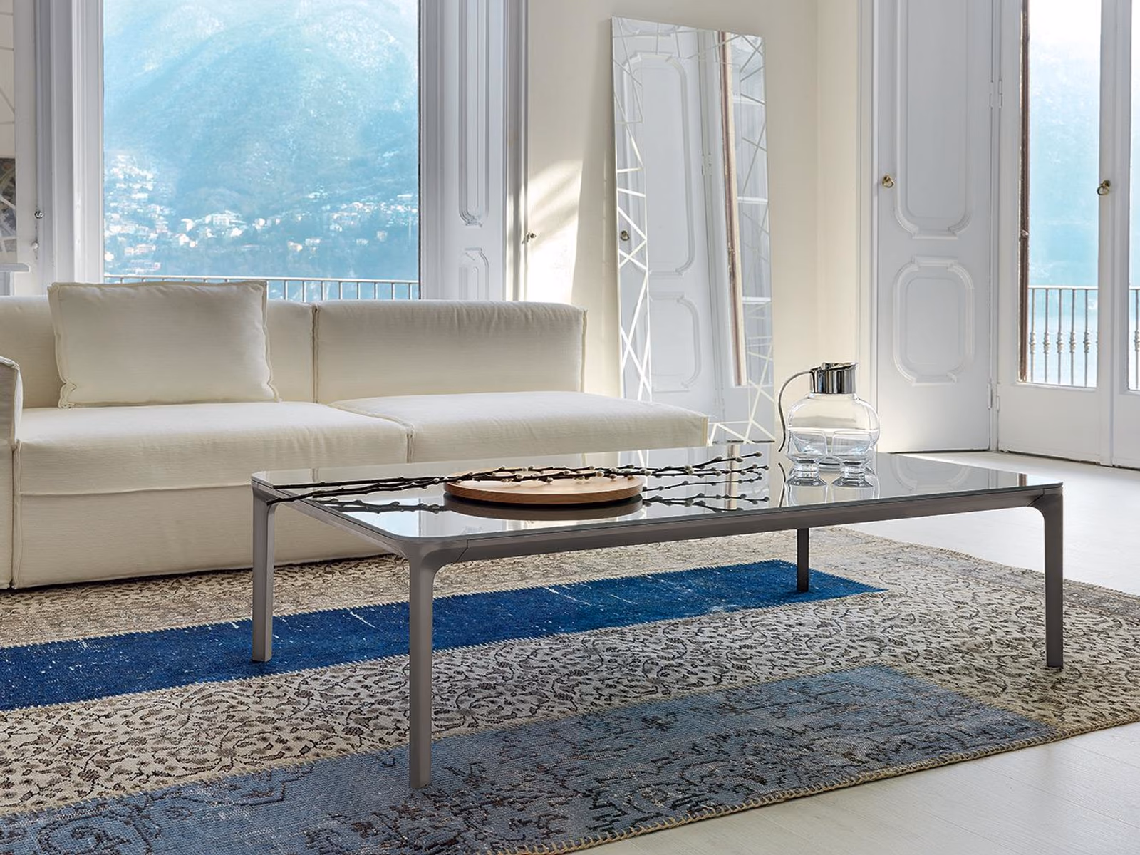Sovet: Slim coffee tables accompany pale sofa seating in a contemporary interior.