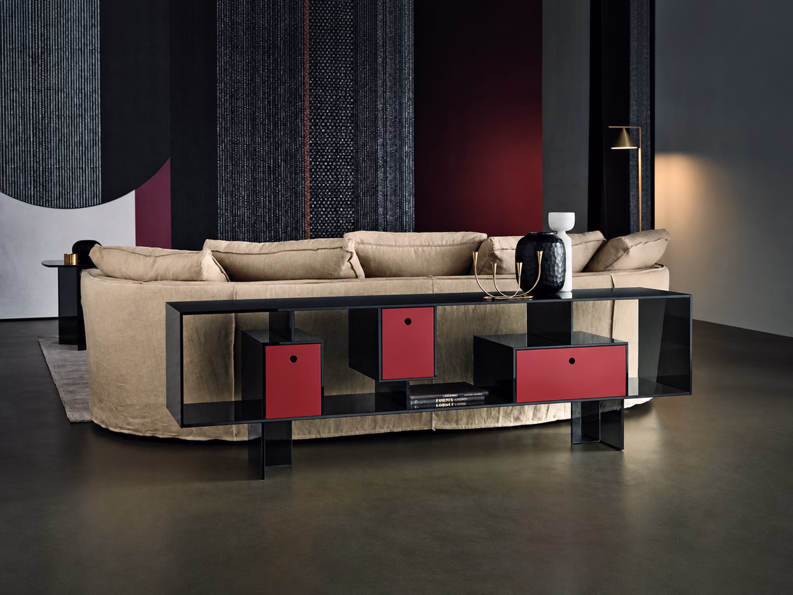 Tonelli: A dark Liber console with colored compartments stands behind a pale sofa.